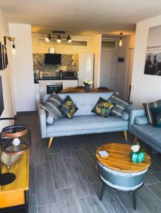 a living room with a couch and a table at Apartment, Paseo Maritimo 33, Perla 6, Fuengirola, Malaga, Spain. in Fuengirola