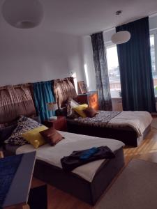 a hotel room with two beds and a couch at ToTuToTam_02 in Warsaw