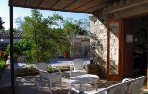 a group of chairs and a table on a patio at La Piccola Locanda in Modica