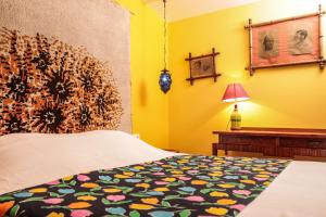 a bedroom with a bed and a yellow wall at La Petite Calanque in Marseille