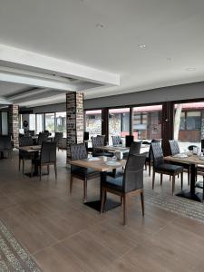a dining room with tables and chairs and windows at Divine Beach Resort Kumburgaz in Büyükçekmece