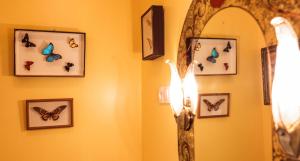 a room with butterflies on the wall and a mirror at La Petite Calanque in Marseille