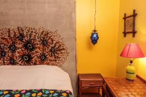 a bedroom with a bed and a table with a lamp at La Petite Calanque in Marseille
