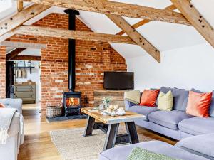a living room with a brick wall and a fireplace at 4 bed in Sidmouth 53068 in Payhembury