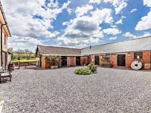 an exterior view of a building with a gravel driveway at 4 bed in Sidmouth 53068 in Payhembury