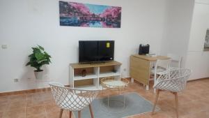 a living room with two chairs and a television at Ocean View Paradise 1116 in Adeje