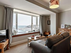 a living room with a couch and a large window at 1 Bed in Brixham BX044 in Brixham
