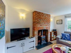 a living room with a fireplace and a flat screen tv at 3 Bed in Whitstable WCC12 in Whitstable