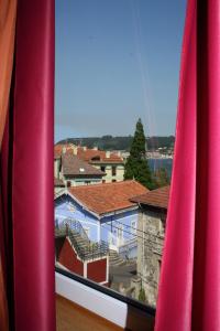 a view of a city from a window at Hotel Kerala in San Esteban de Pravia