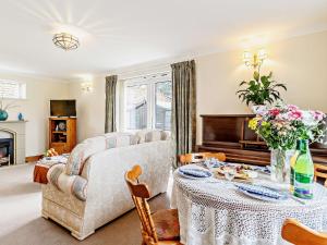 a living room with a couch and a table at 2 Bed in Mattishall 57133 in Mattishall