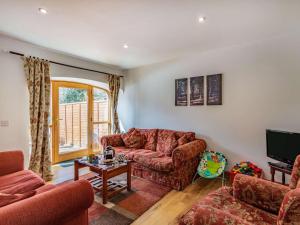 a living room with a couch and a tv at 3 Bed in Huntly 57368 in Insch