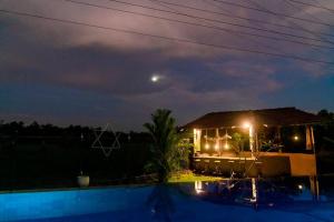 a house with a swimming pool at night at Peaceful Villa with pool near Hikkaduwa in Ambalangoda
