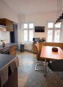 a kitchen with a table and a dining room at NEU! Ferienidyll Nähe Plauer See in Halenbeck