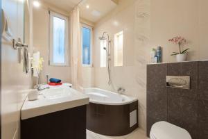 a bathroom with a sink and a tub and a toilet at Szent Istvan ter 4 Next to Basilica a 1 BedRoom in Budapest