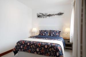 a bedroom with a bed with a blue comforter at Villa Khaleesi in Playa Blanca +22 photos