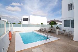 a swimming pool on the roof of a house at Villa Khaleesi in Playa Blanca