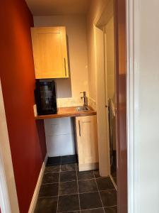 a small kitchen with a counter and a microwave at The Hanmer Arms in Hanmer