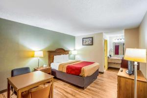 a hotel room with a bed and a desk at Econo Lodge Huntington - Barboursville University Area in Huntington