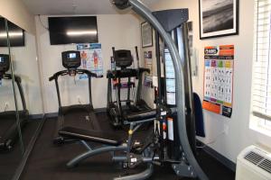 a gym with two tread machines in a room at Wingate by Wyndham Kings Bay Naval Base in Kingsland