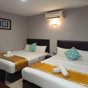 a hotel room with two beds and a heater at Royale City Hotel - 10 min from KLIA KLIA 2 Airport in Sepang
