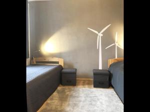 a bedroom with two beds and two wind turbines at NEU! FeWo Kornkammer Nähe Plauer See in Halenbeck