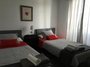 a bedroom with two beds with towels on them at Apartamentos cercanos playa 1 in Puentedeume