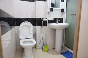 a small bathroom with a toilet and a sink at Agdal 1 in Rabat