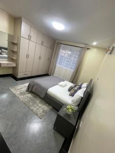 納庫魯的住宿－Naka Tranquil Suite with Ample Secure Parking，一间卧室设有一张大床和一个窗户。