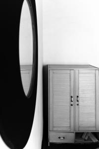 a mirror next to a dresser and a cabinet at Vintage Charm Residence in Kigali