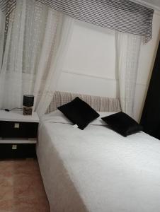 Un ou plusieurs lits dans un hébergement de l'établissement Habitaciones Privadas Tranquilo