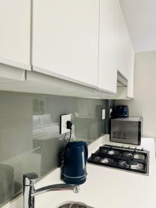 a kitchen with a sink and a stove top oven at Sibaya Umhlanga Apartments in Umhlanga