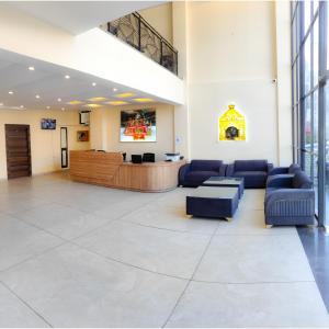 a lobby with couches and a waiting room at The Fragrance Hotel in Katra