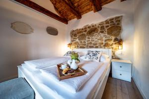 ein Schlafzimmer mit einem Bett und einem Tablett mit Essen drauf in der Unterkunft House Filumena in Lopar