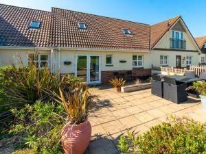 a house with a patio with plants in the yard at 3 bed in Brighstone IC041 in Brighstone