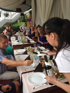 a group of people sitting at tables eating food at Triumph Holiday Village in Sveti Vlas +17 photos