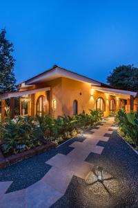 a house with a pathway in front of it at SaffronStays Athaang, Dapoli in Ānjarle