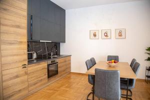 a kitchen with a table and chairs in a room at Spacious apartment in Pagkrati in Athens