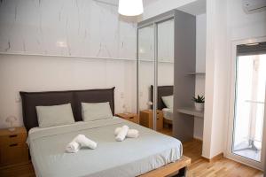 a bedroom with a bed with towels on it at Spacious apartment in Pagkrati in Athens