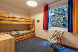 a bedroom with bunk beds and a desk and a chair at Casa Cresta A31 in Arosa +75 photos