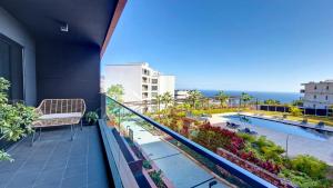 an apartment balcony with a view of a swimming pool at Roots Loft by LovelyStay in Funchal