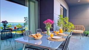 a blue table with baskets of food on a balcony at Roots Loft by LovelyStay in Funchal