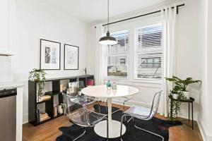 a white dining room with a table and chairs at Cozy Apartment in Virginia Highland in Atlanta