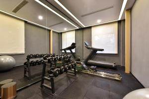 a room with a gym with lots of weights at Atour Light Hotel Shenyang Tiexi Plaza Wanxianghui in Shenyang