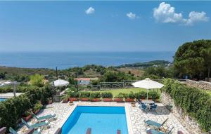 a pool with chairs and umbrellas and the ocean at Lassi SeaView Villa - Private Pool - Villa Efrosini - Short Walk to Resort Centre in Kefallonia
