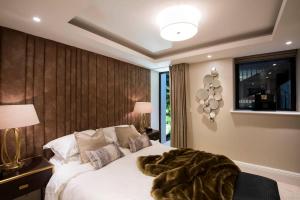 a bedroom with a bed with a blanket on it at New, luxury 3 bed duplex in Covent Garden in London
