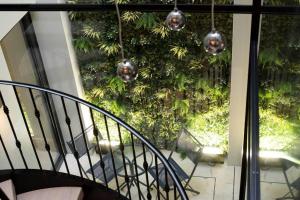 a balcony with a spiral staircase and a tree at New, luxury 3 bed duplex in Covent Garden in London