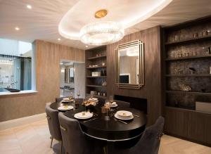 a dining room with a black table and chairs at New, luxury 3 bed duplex in Covent Garden in London