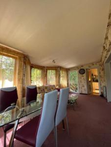 a dining room with a glass table and chairs at MAXX Lodge in Bacău