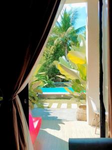 a window view of a pool from a bus at Larue Pocket Villa in Calatagan