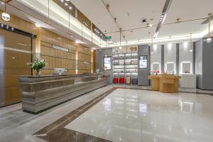 a lobby of a store with a laptop on a counter at Atour Hotel Chengdu North Renmin Road in Chengdu